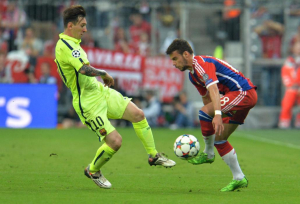 Barcelona's Lionel Messi fights for the ball against Bayern's Juan Bernat  during the soccer Champions League second leg semifinal match between Bayern Munich and FC Barcelona at Allianz Arena in Munich, southern Germany, Tuesday, May 12, 2015. (AP Photo/Kerstin Joensson)